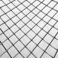 Close-up of a metal grid displaying a geometric pattern, creating an artistic effect.